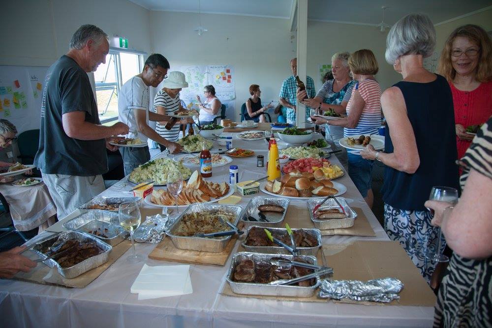 Picture of several choir having a shared lunch